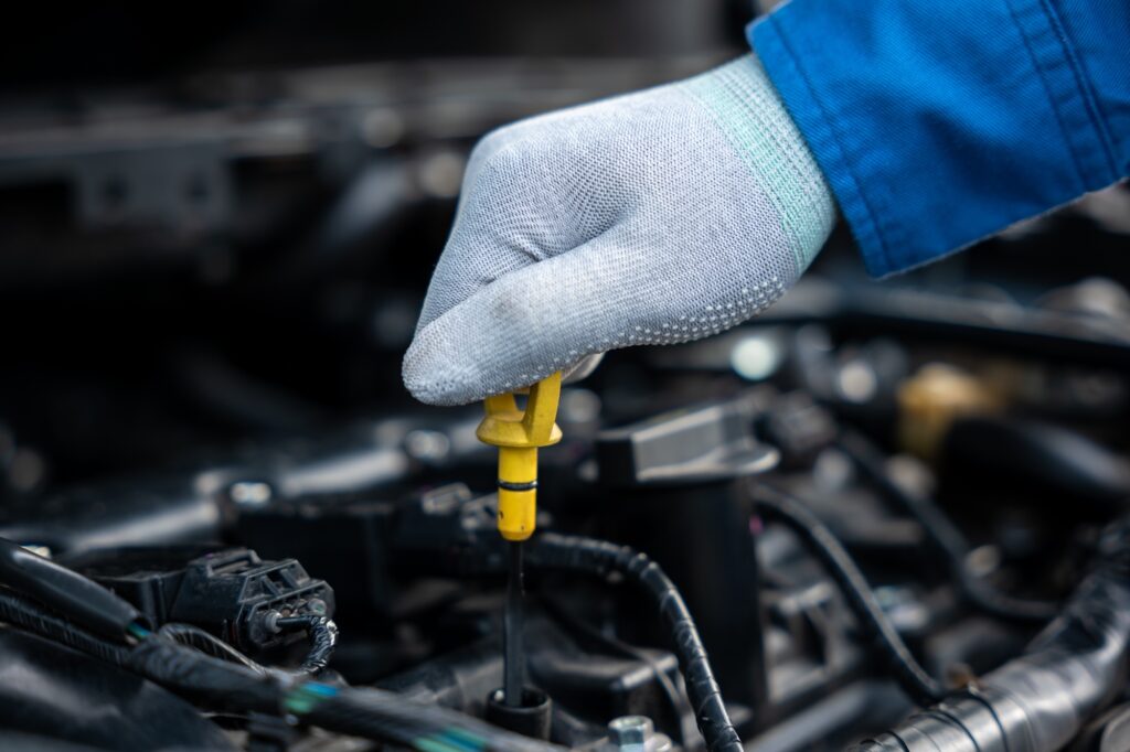 Cropped Hands Of Mechanic maintain car