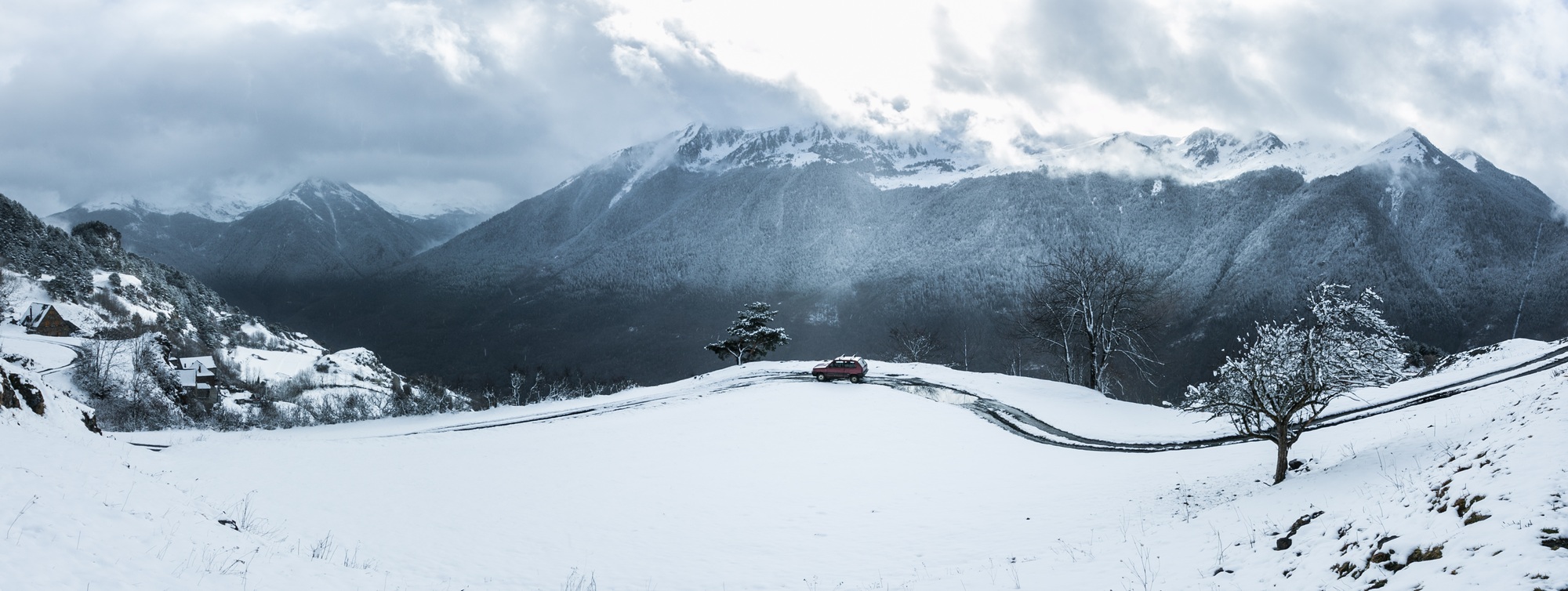 Red car driving in mountains